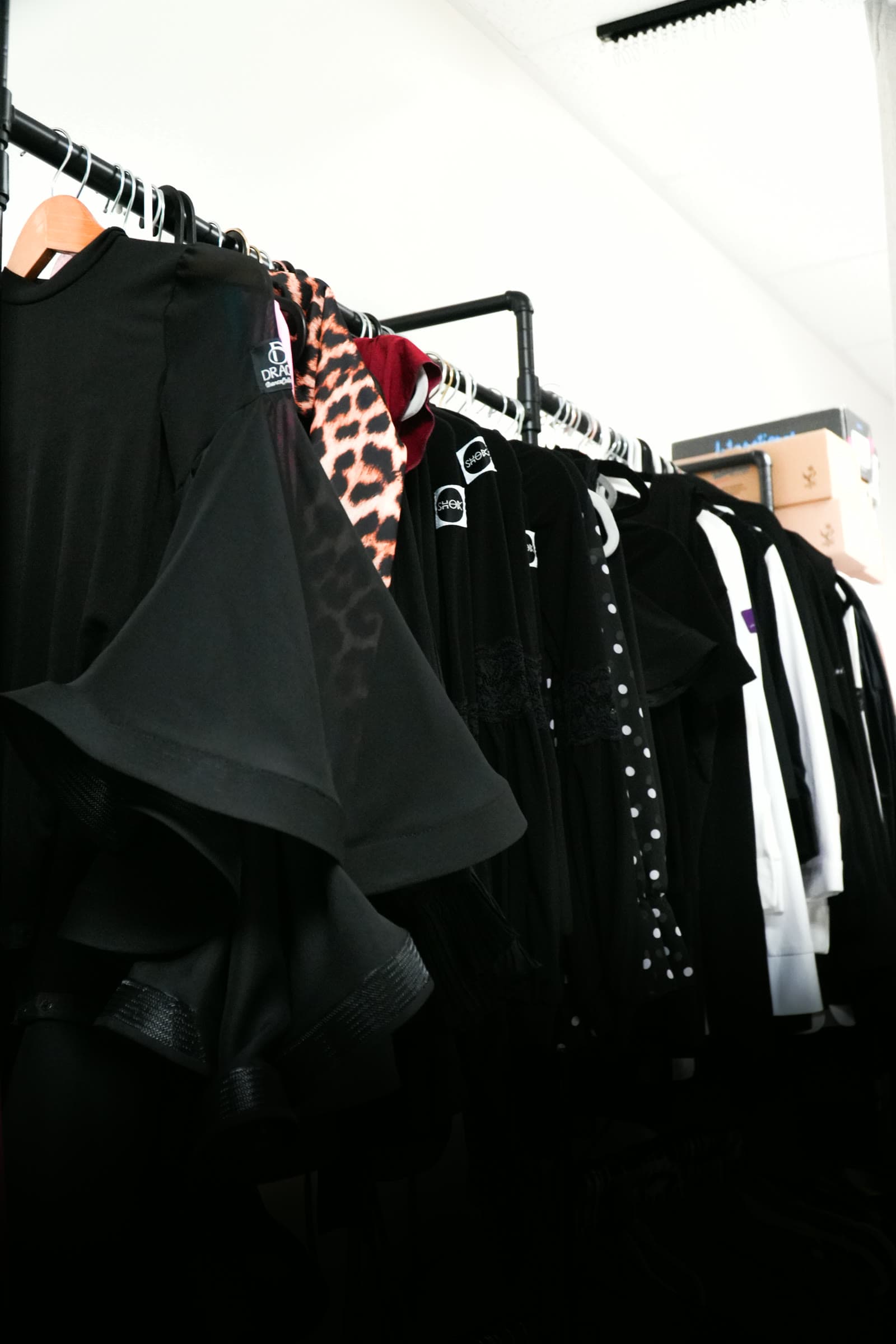 Practice wear on the rack, including Shok brand tops